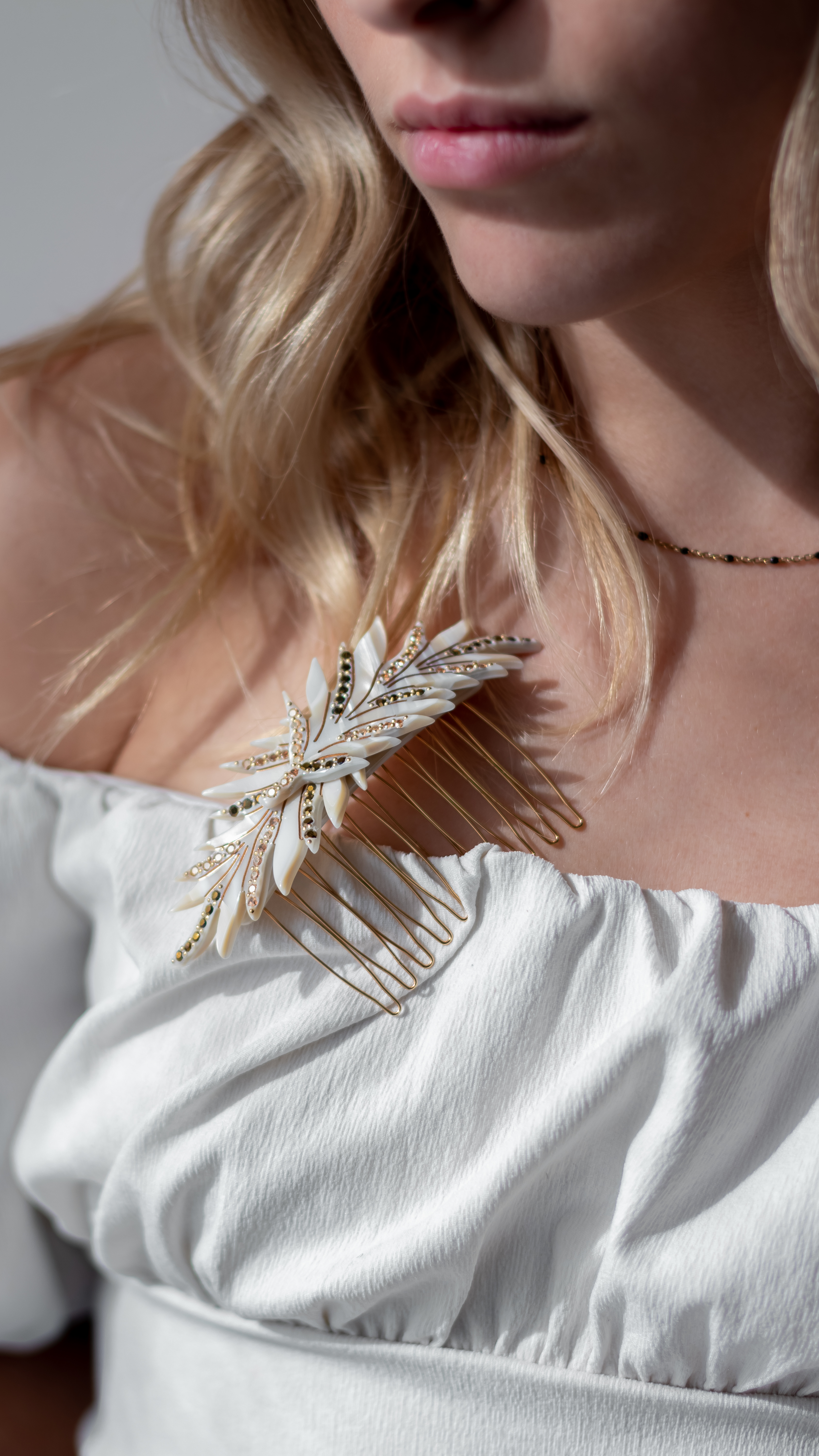 Close-up of MC Davidian Feathers Brillant Golden Comb MM worn in a hairstyle — decorative French hair comb handmade in France